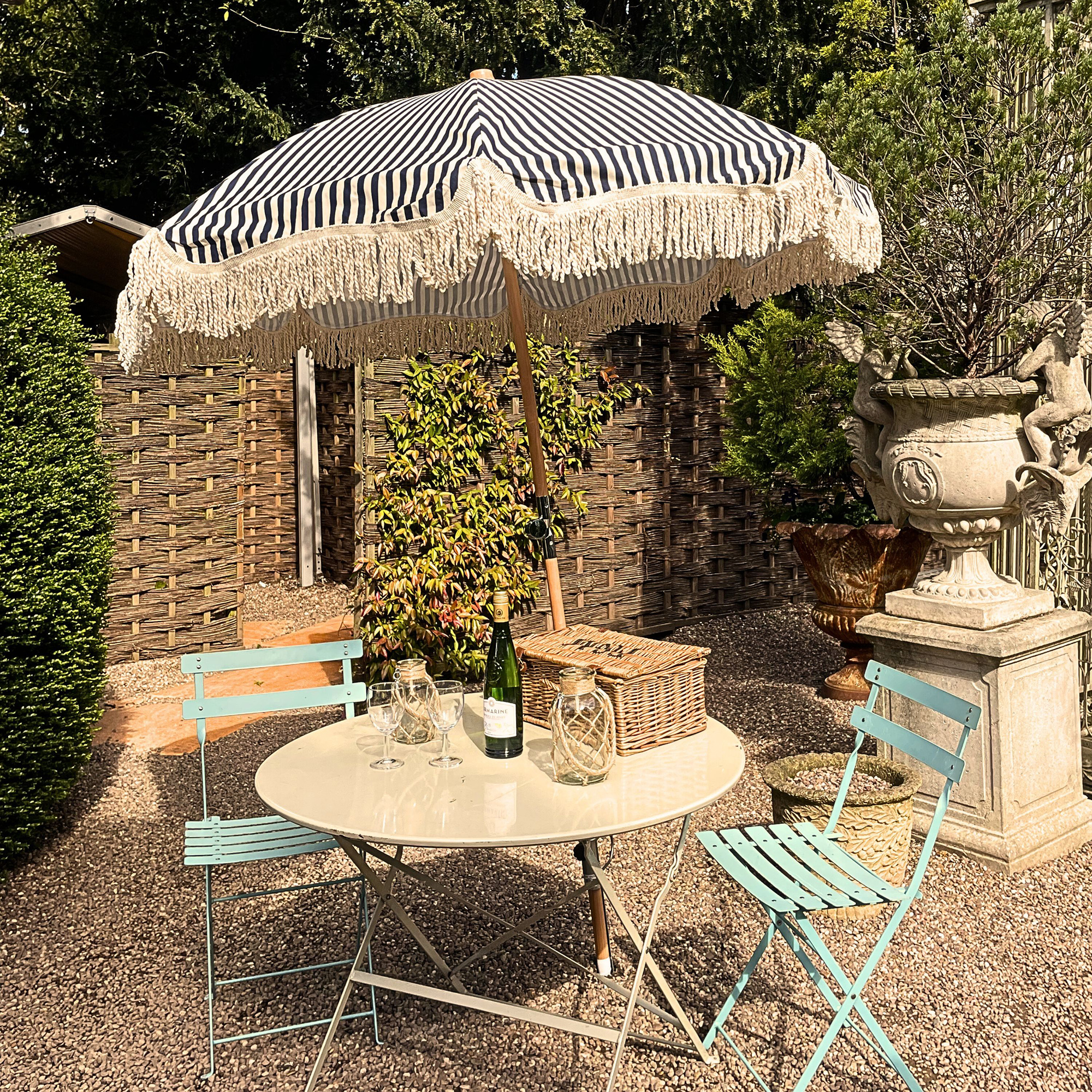 Striped parasol over bistro table set