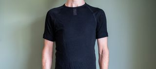 A man wearing the Rapha Merino base layer 