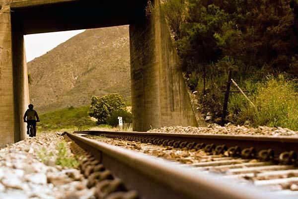 A rider squeezes alongside the tracks.