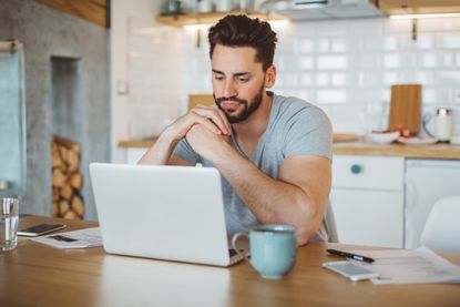 Young man worried about his finances at home. 