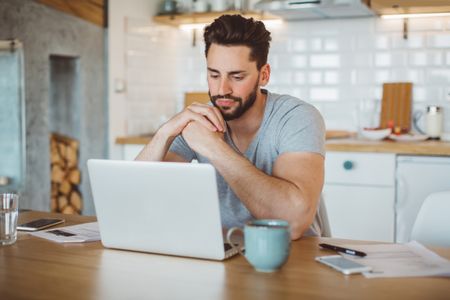Young man worried about his finances at home. 
