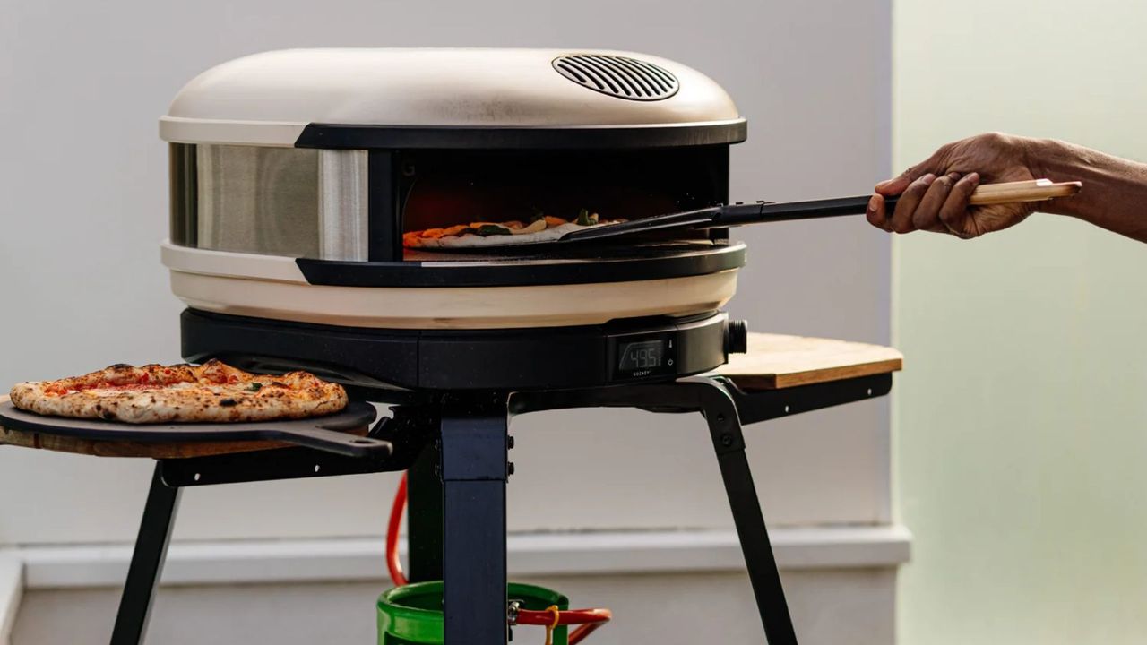 The Gozney Arc Pizza Oven, lit and being used to cook
