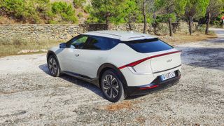 Rear on, at an angle, view of Kia EV6 parked in a layby in the mountains