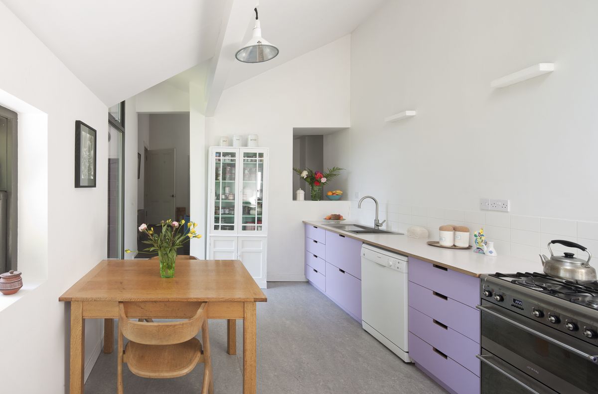 The purple Formica was chosen, in part, as a reference to the original 1950s conversion. The floors here, and in the dining and utility room, are laid with Marmoleum.