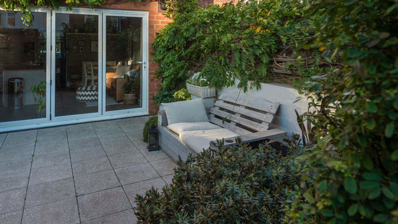 A patio with a garden bench