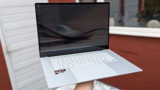 ASUS Zenbook S 16 held at arm's length