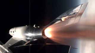 A rocket with engines firing in space. Toward the right, the Earth.