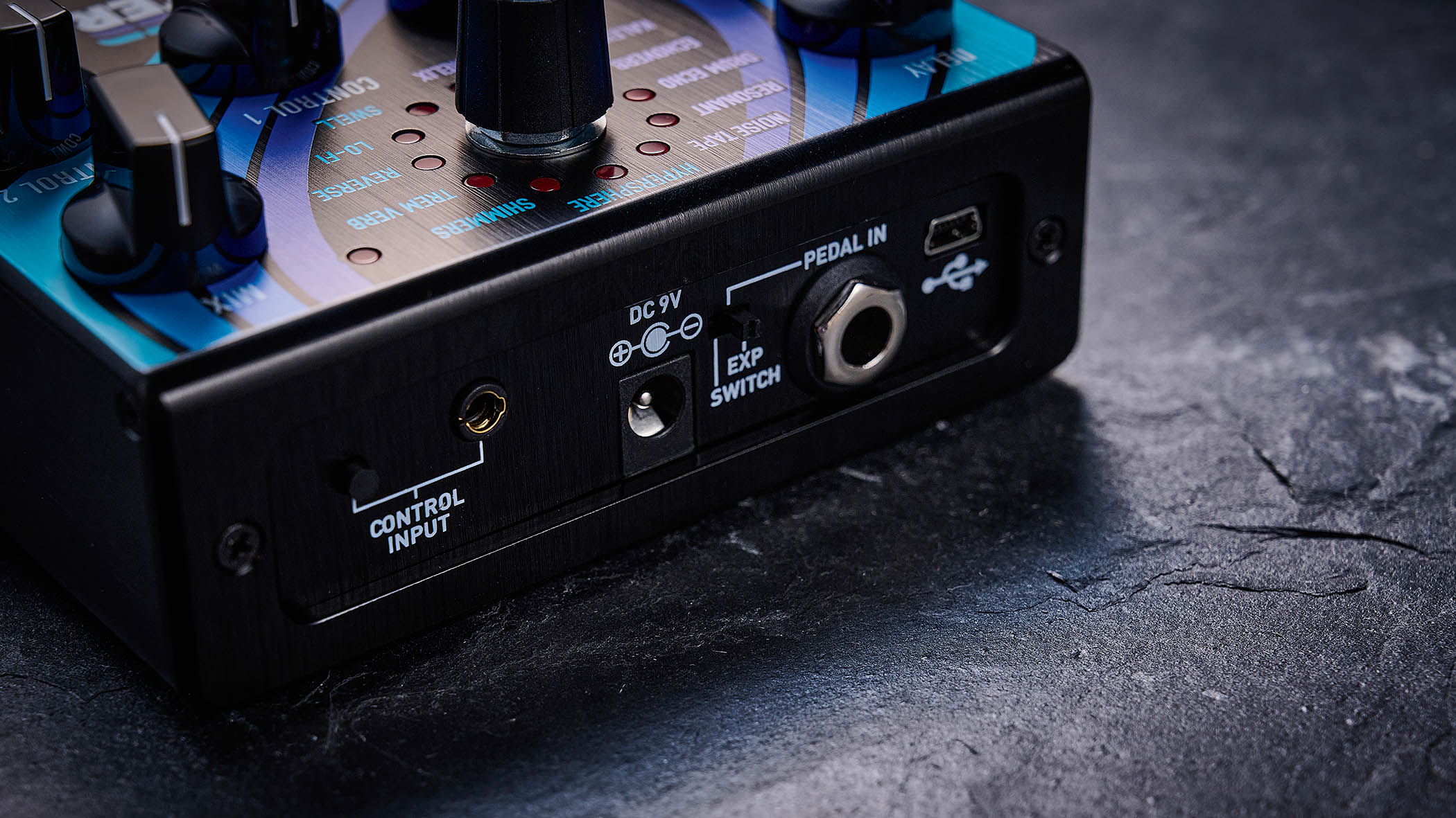 The Source Audio delay/reverb is photographed in close-up up against a slate background.