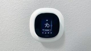 ecobee SmartThermostat installed a wall with temperature controls on display.