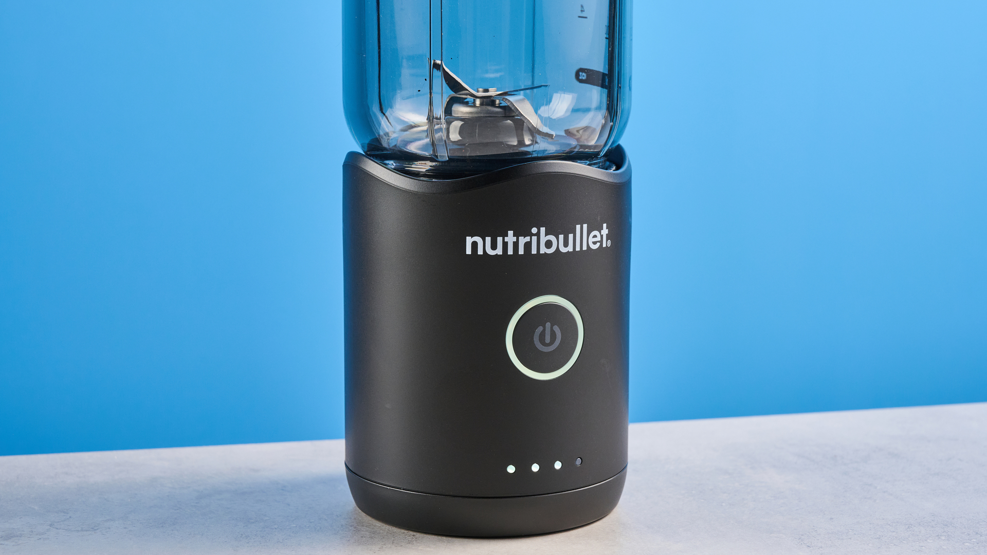 Nutribullet Flex blender photographed on a blue background