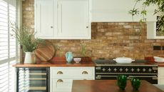 shaker kitchen with white cabinest and exposed brick