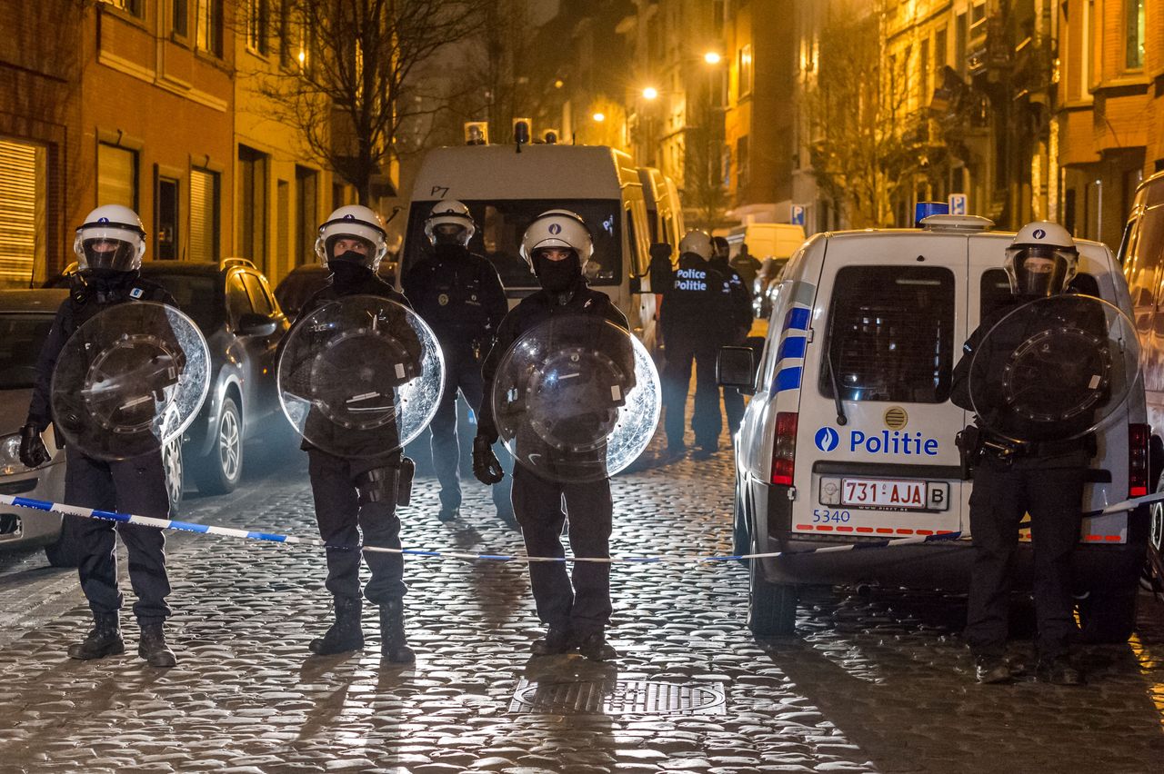 Belgian police block off a street during a raid in Brussels.