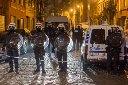 Belgian police block off a street during a raid in Brussels.