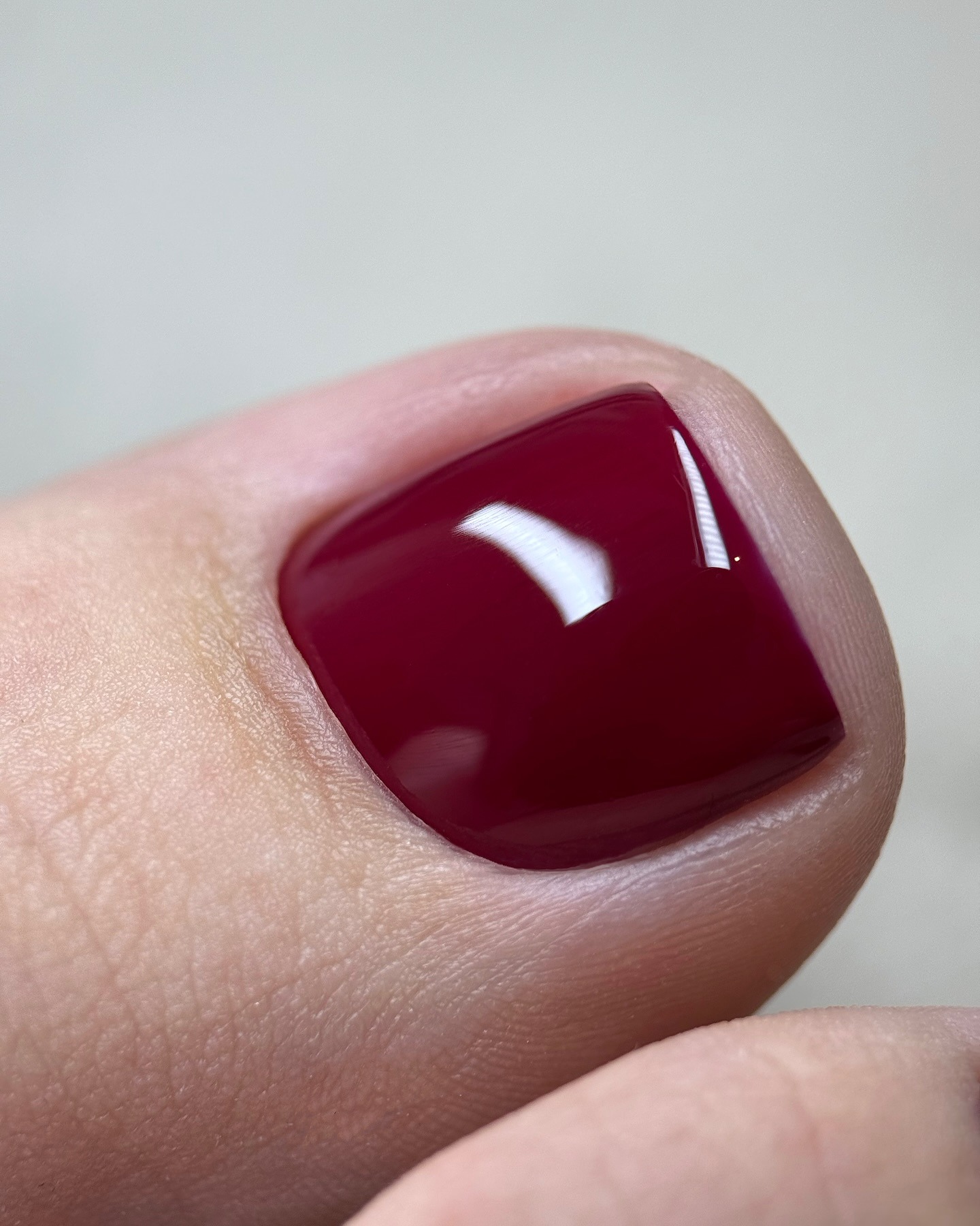 A close-up picture of a deep red pedicure