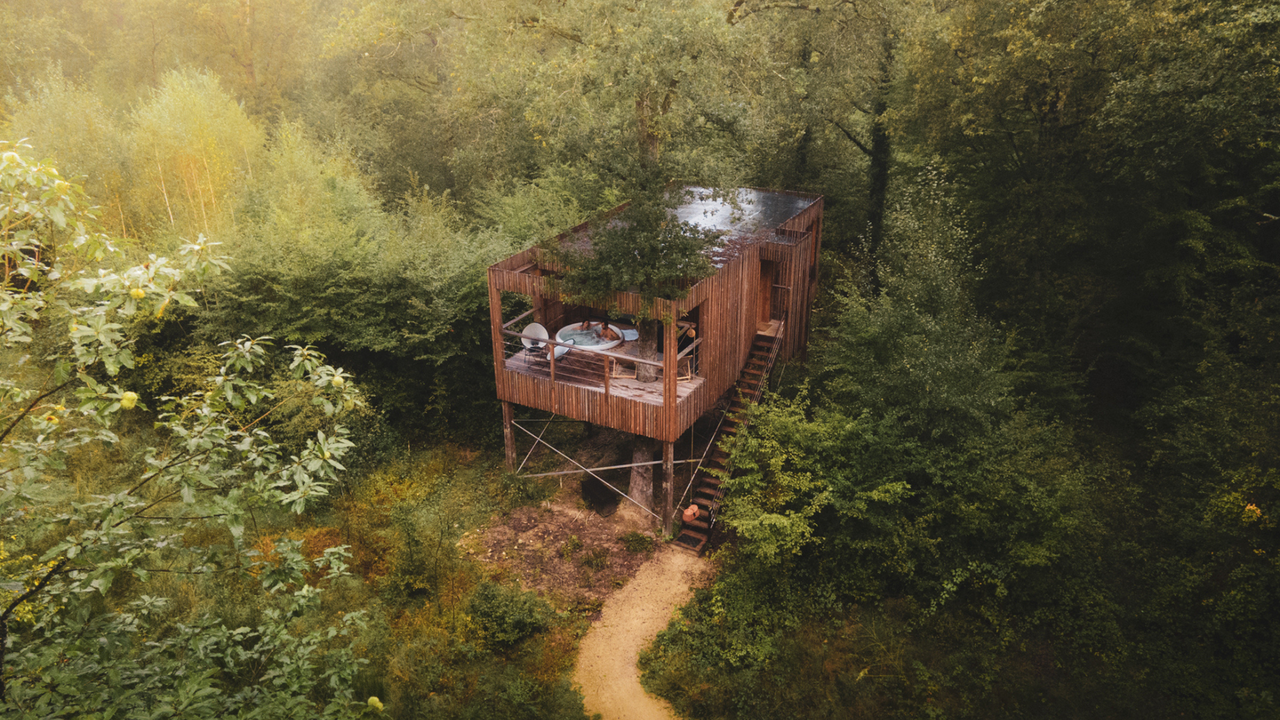 An aerial shot of a suite at Loire Valley Lodges, showing a couple in a Jacuzzi hot tub