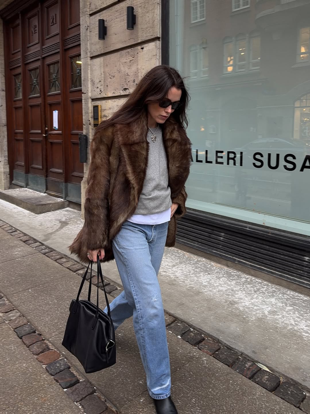 Woman wearing layering outfit idea 2026.