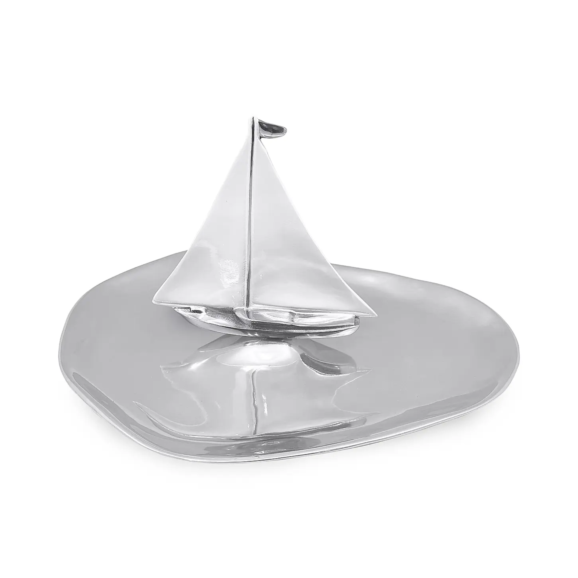 silver platter with a silver sailboat standing in the center