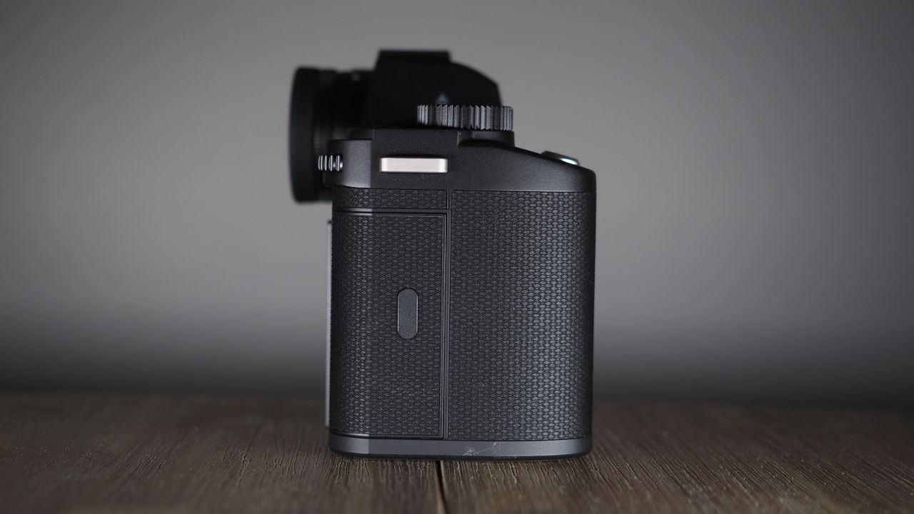 Leica SL3-S on a wooden surface with moody lighting