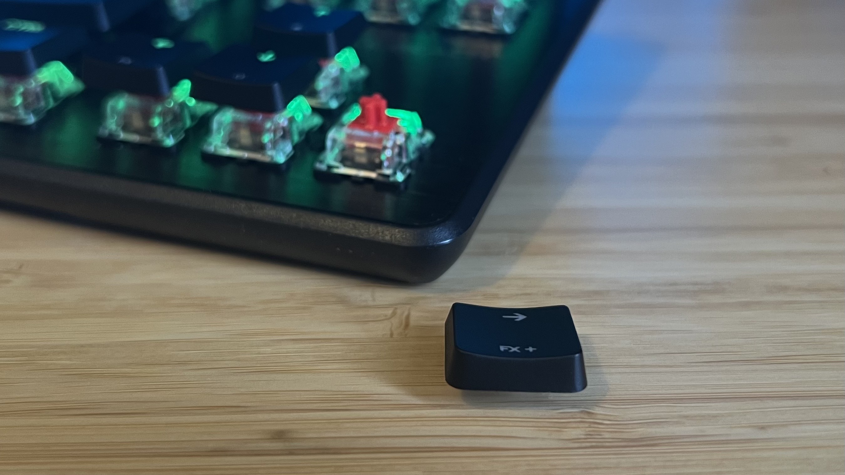 Close up on keycap from Turtle Beach Vulcan II TKL gaming keyboard with arrow keys in the background