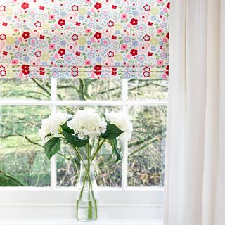 Graphic floral blinds covering white window