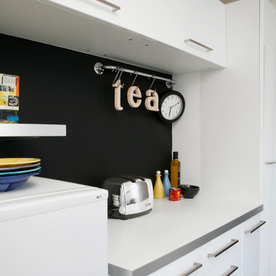 Kitchen with white cabinet and white walls