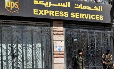 Yemeni soldiers stand guard outside a Yemen UPS office after two packages containing bombs addressed to Chicago synagogues were intercepted.