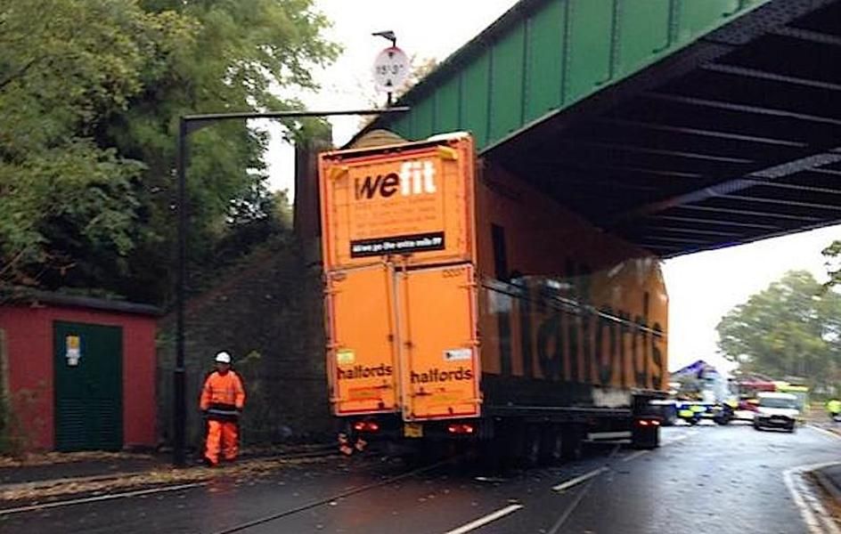 Truck sporting the motto &amp;#039;We Fit&amp;#039; got stuck under a bridge