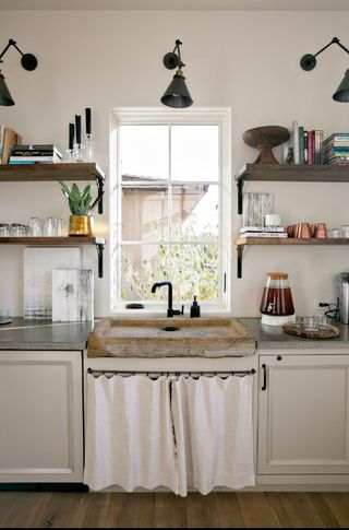 Kitchen window with shelving on either side