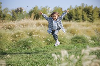 Child skipping in a field