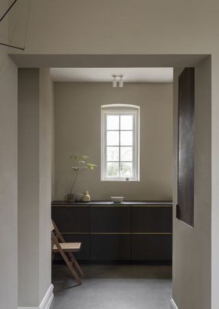 Dark kitchen cabinets with moody grey walls