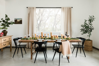 A rectangular dining table with places set