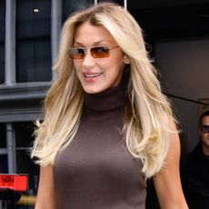 Bella Hadid attended an Orebella event wearing a denim midi dress, cowboy boots, and a cropped Penny Lane coat