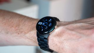 The official Google metal band on the Pixel Watch in black