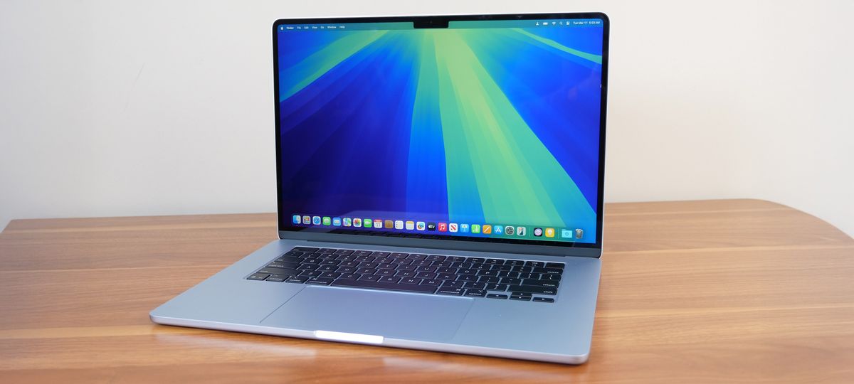 Apple MacBook Air 15-inch M4 on a wooden table with the macOS Sequoia desktop.