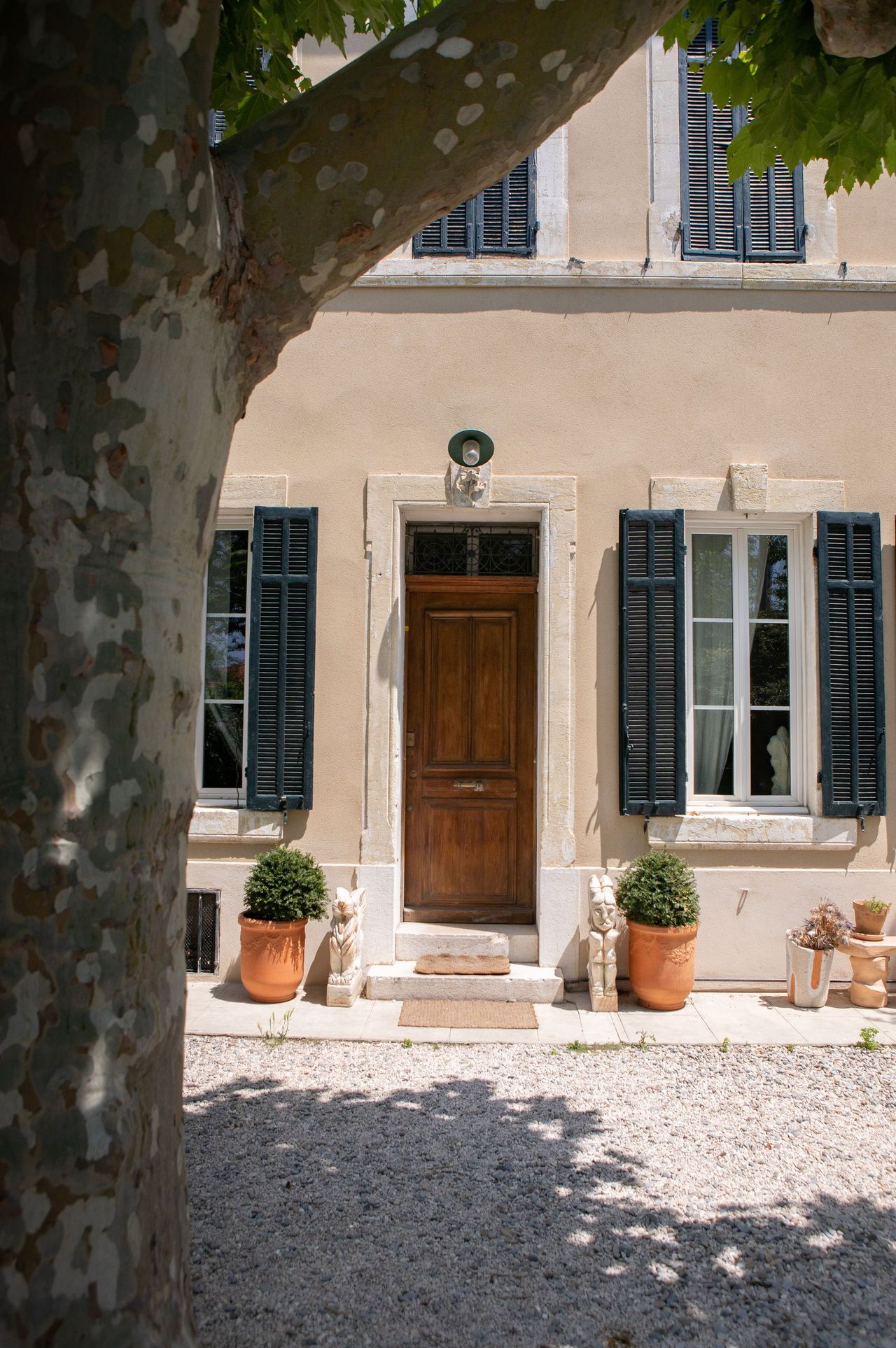 The stone, buttery facade of a palatial building is captured in morning light.