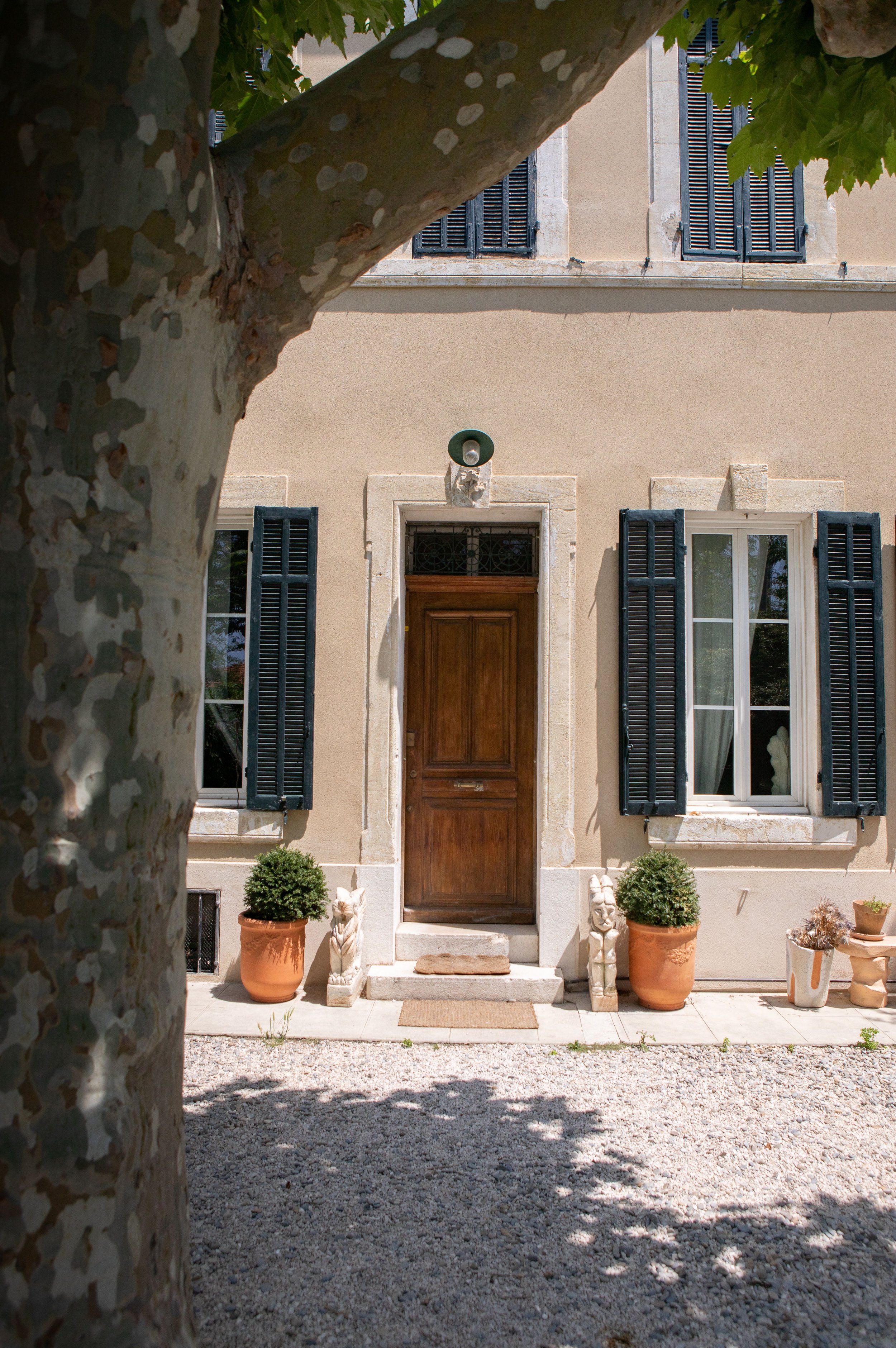 The stone, buttery facade of a palatial building is captured in morning light.