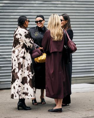 Jasmine Fox-Suliaman wearing a gold brooch during new york fashion week.
