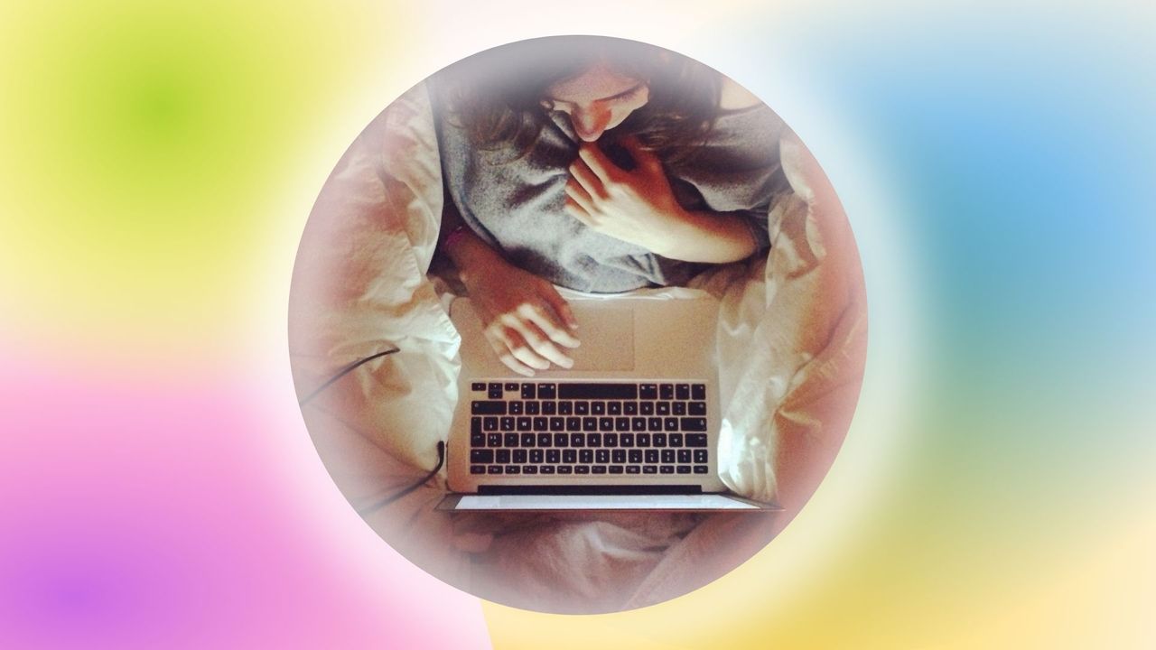 woman using laptop on bed; symbolizing most googled sex questions