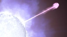 Against a cloudy white and purple background, part of a bright blue-white star is visible at lower left. Emerging from the star and stretching diagonally across the frame is a narrow line, looking white nearest the star and becoming magenta farther away. At far right, the line &mdash; one of the dying star&rsquo;s particle jets &mdash; forms a large, rounded blob. 