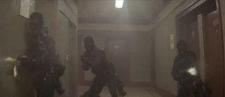 The S.W.A.T. team fires blindly through the sprinkler water in