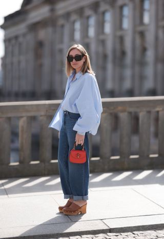 Woman in jeans and clogs