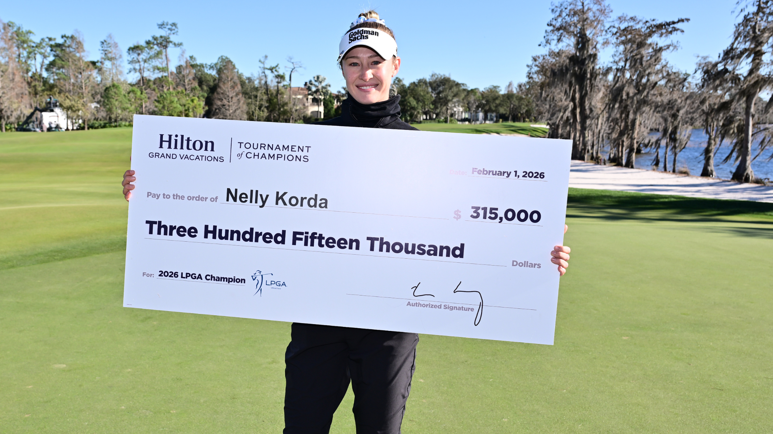 Nelly Korda with a cheque after winning the Hilton Grand Vacations Tournament of Champions
