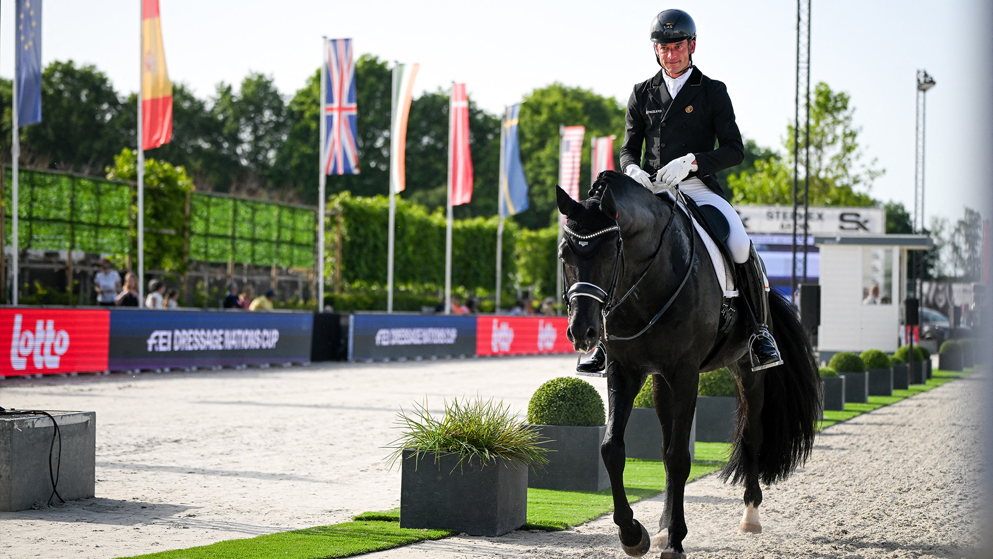 Justin Verboomen riding Zonik Plus on a long rein at a dressage championships