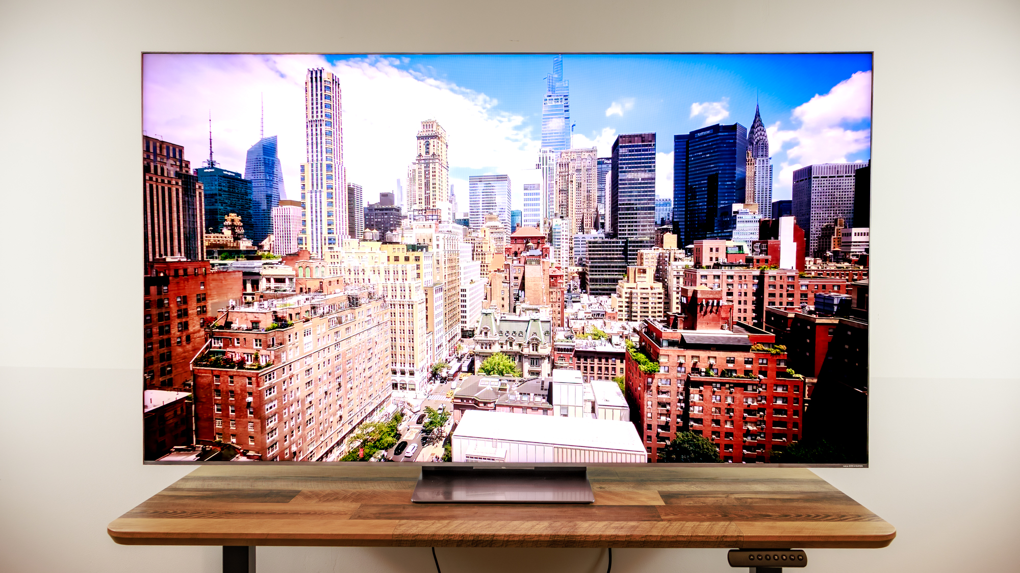 A TCL QM8L TV on a desk