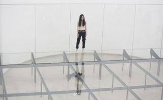 Dancer stood at the edge of glass and metal circular platform