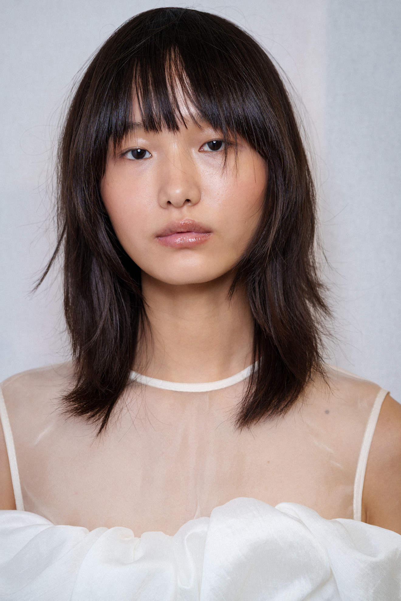 A model wearing their hair in a shag haircut.