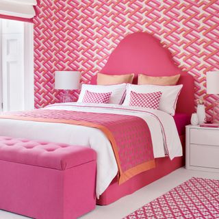 bedroom with pink designed wall pink bed with pink designed cushion with lamp