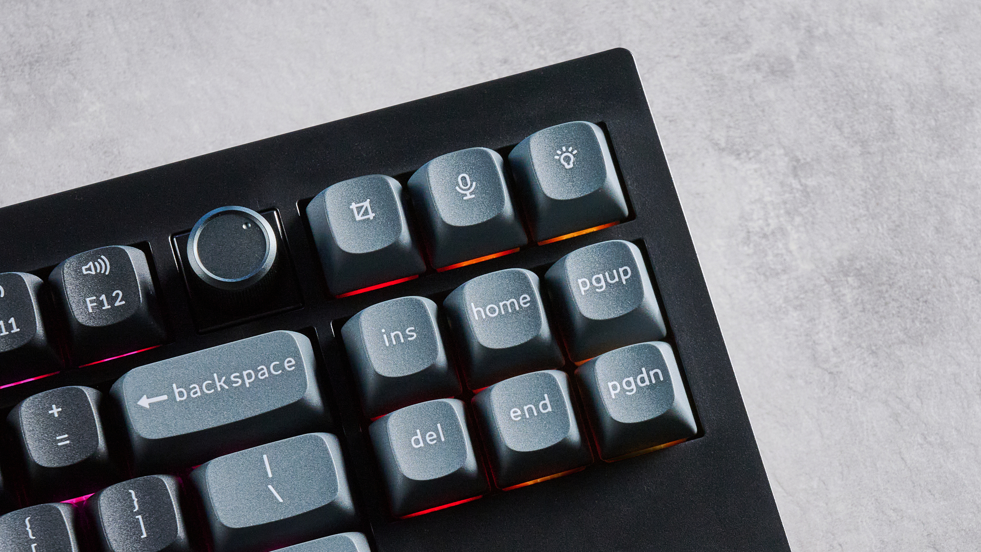Keychron V3 Ultra 8K photographed on a grey table top in front of a blue background