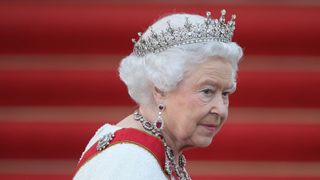 How to talk to kids about the Queen's death illustrated by Queen on red carpet wearing tiara