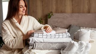 Woman folding bedding